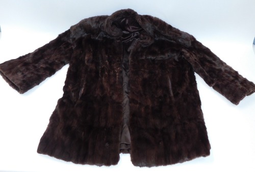 A brown full length coat, dark brown with silk lined interior.