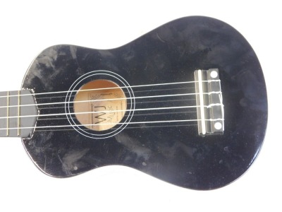 A W J Music ukulele, bearing label Model WJ-UK-BK, in black, with material carry case, 54cm high. - 2