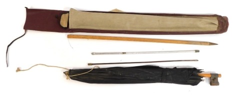 A vintage fishing umbrella, in canvas bag.