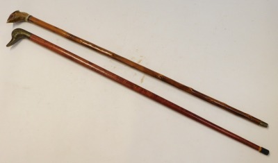 Two walking sticks, comprising a brass duck handled stick and a resin pheasant mounted stick, 93cm long. - 2