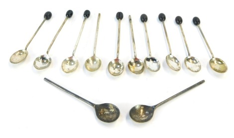 A matched set of twelve silver teaspoons, with coffee bean design top, four lacking top, mixed years and dates, circa George V and later, 2½oz gross.