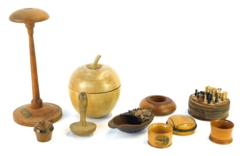 A group of treen, comprising an ebony apple trinket box, a turned teak candlestick with crest from the teak of HMS Iron Duke, flag ship 1916, sock darns, part trinket boxes, miniature travel chess set, etc. (a quantity)