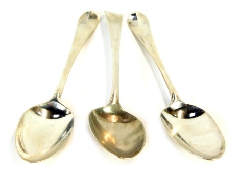 Three Victorian silver serving spoons, comprising a pair of silver Fiddle pattern serving spoons, London 1841, each inscribed W T S, and a further later example London 1922, 5½oz.