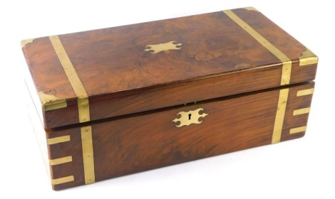 A 19thC walnut campaign writing box, with brass bound supports and escutcheon, with writing slope with a red leather lined interior, 70cm high 50cm wide and 25cm deep