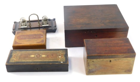 A collection of 19thC and later boxes and ink wells, comprising a ebony and ebonised ink well, eastern inlay box, 19thC mahogany tea caddy, mahogany writing slope lacking interior and a handkerchief box (5)