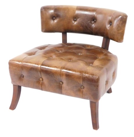 A brown button back club chair, the shaped and moulded back on stained pine legs. The upholstery in this lot does not comply with the 1988 (Fire & Fire Furnishing) Regulations, unless sold to a known exporter or upholsterer it will be cut from the frame b