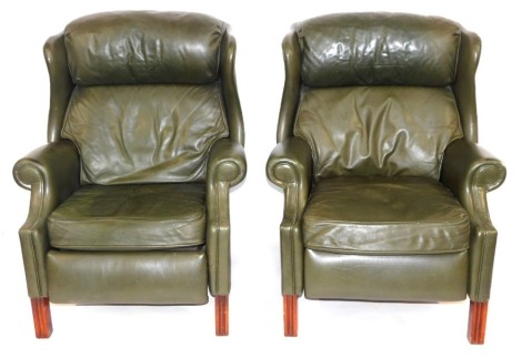 Two green leather reclining Chesterfield style armchairs, each with buttoned detail, 113cm high, 83cm wide, 82cm deep. The upholstery in this lot does not comply with the 1988 (Fire & Fire Furnishing) Regulations, unless sold to a known exporter or uphols