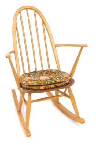 An Ercol light elm rocking chair, bearing label, 77cm high, 71cm deep and 42cm wide.