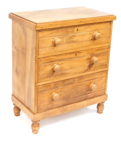 A pine three drawer chest, with bun handles on bun feet, 89cm high, 75cm wide, 40cm deep.