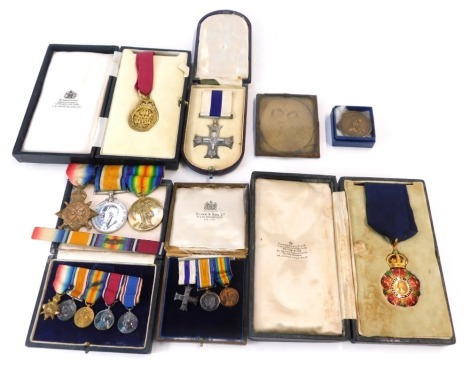 A group of medals relating to members of the Hopkinson family, a WWI trio named to Second Lieutenant F Hopkinson, Durham Light Infantry, Military Cross, possibly that of C.E Hopkinson five WWI Military cross and other miniatures, a neck badge of a Comman