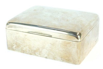 A George V silver cigarette box, inscribed Beresford CEH 1920-1932 with engraved horseshoe, wooden lined interior, maker HM, Birmingham 1931, 23oz gross, 6cm high, 18cm wide, 14cm deep.