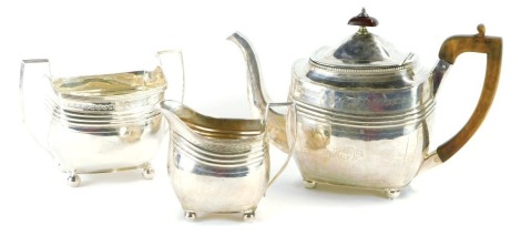 A Georgian silver three piece tea set, of reeded and bright cut decorated form and having gadrooned border under the lid, maker Peter & William Bateman, London 1806, teapot 17oz gross, sucrier 8oz, creamer 5oz. (3)