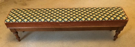 A Victorian mahogany long foot stool, with turned legs and wool work seat, 30cm high, 120cm wide, 25cm deep.