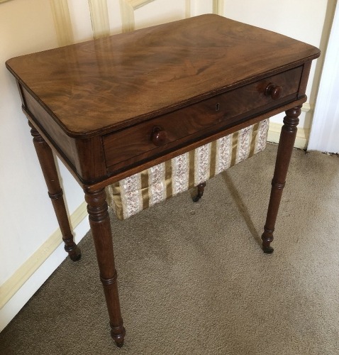 A Victorian mahogany work table, with flamed and moulded rectangular top, frieze drawer with knob handles, turned legs and brass castors, 71cm high, 62cm wide, 42cm deep. (AF)