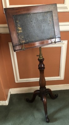 A Victorian mahogany adjustable music stand, on baluster stem and three scrolling legs, 105cm high, 40cm wide. (AF)