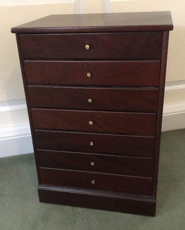 A modern mahogany music cabinet, with seven drop drawers, 70cm high, 48cm wide, 38cm deep.