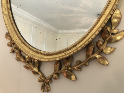 An early 19thC oval giltwood wall mirror, with Neo Classical urn and bell husk decoration, 97cm high. - 3