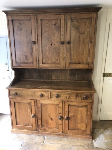 A 19thC style oak dresser, with cabinet top with three panelled doors, the base with three drawers and panelled doors, 215cm high, 153cm wide, 54cm deep.