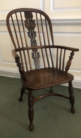 A 19thC ash and elm high back Windsor chair, with Christmas tree splat, and crinoline stretcher.