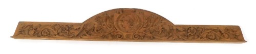 A late 19th/early 20thC carved oak panel, decorated with torches, scrolls, etc,169cm wide, 32cm high at centre point