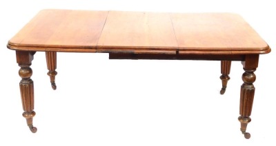 A Victorian mahogany extending dining table, with two loose leaves on reeded turned legs and casters, 72cm high, 103cm wide, the top 221cm minimum plus 52cm leaf, x 102cm.