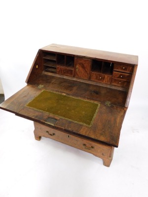 A George I walnut bureau, the fall opening to reveal a fitted interior, plate above arrangement of one long, two short and two long drawers on bracket feet, 106cm high, 91cm wide, 52cm deep. (AF) - 5