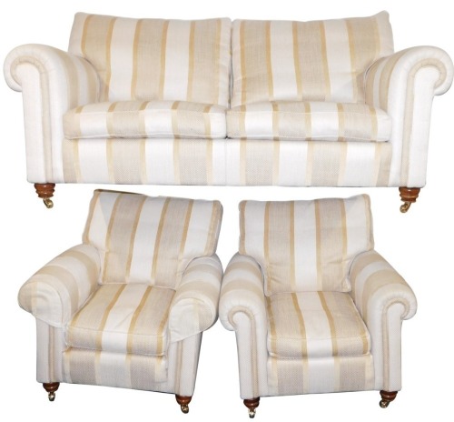 A Duresta sofa suite, comprising a two seater sofa and two armchairs, each with a gold and cream upholstery, the sofa 97cm high, 182cm wide, 84cm deep, the armchairs 97cm high, 87cm wide, 84cm deep. (3)