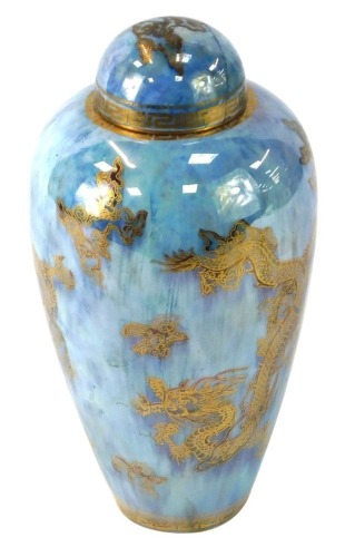 A Wedgwood Dragon lustre jar and cover, the bulbous shaped stemmed vase on a blue ground, stamped Wedgwood England, No 4829, 22cm high. (AF)