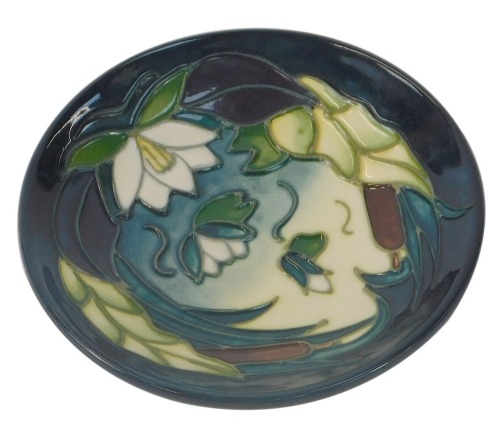 A Moorcroft pin dish in the water lilies and fern pattern, c1995, signed R M, 11.5cm diameter.