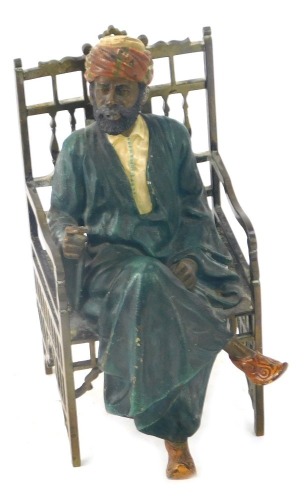 An Austrian cold painted metal figure of an Arabian gentleman seated upon throne, in elaborate head dress and blue brass throne seat, 16cm high.