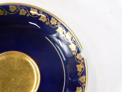 A 20thC Sevres style cup and saucer, on a cobalt blue glaze, with gilt vine detail and Napoleon crest, orange stamp to underside, stamped S57, the cup 5cm high, the saucer 14cm diameter. - 3