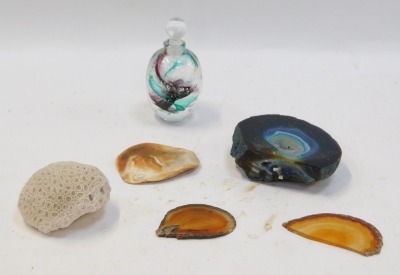 A group of crystals and glassware, comprising an ammonite shell, a blue geode, various agate slices, and a green and pink swirl art glass bottle and stopper. (6)