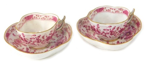 A pair of Meissen coffee cans and saucers, each with fluted and gilt rims, with pink painted flowers and blue cross marks to underside. (AF)