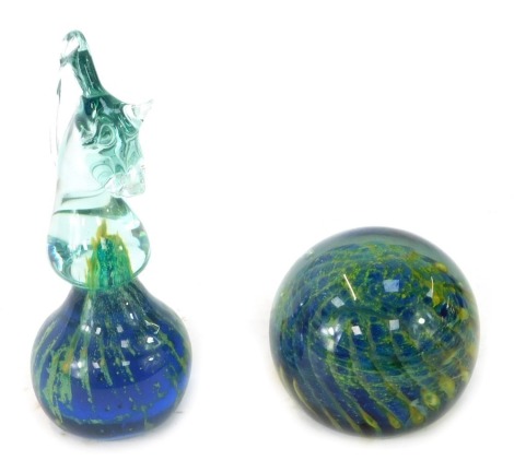 Two Mdina glass paperweights, comprising a seahorse, 16.5cm high, and a paperweight, each of similar design with blue, yellow and green twist detail, the paperweight 7cm high. (2)