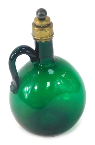 A 19thC green glass wine jug, with brass mount and capped cork stopper, 21.5cm high.