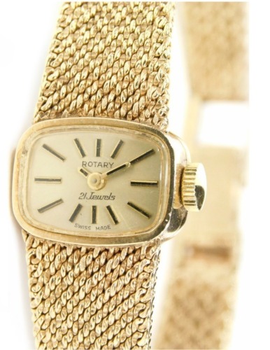 A 9ct gold Rotary cocktail watch, with oblong face, baton numerals and pointers, twenty one jewel movement and textured bracelet, 2cm wide face, 27g all in.