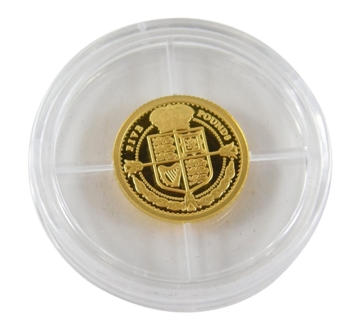 A 24ct gold 2021 laurel five pound gold proof coin, 0.5g, in associated packaging, with some paperwork.