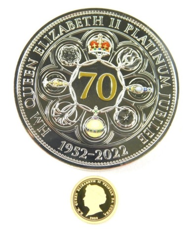 A Queen Elizabeth II with laurel gold proof five pound coin, 0.5g, in outer case with some paperwork, and a Guernsey Queen Elizabeth II commemorative five pound coin. (2)