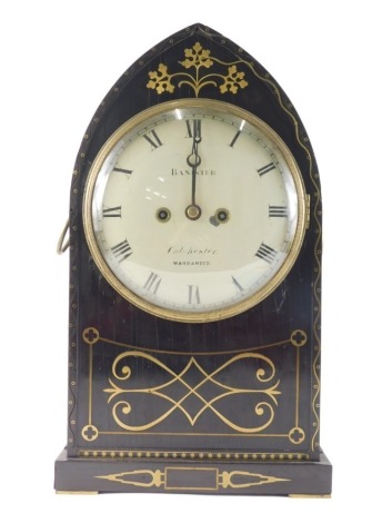 Banister, Colchester. An early 19thC ebony and brass inlaid lancet shaped mantel clock, decorated with scroll, roundels, etc., the painted dial with Roman numerals, the brass movement also engraved with the maker, 46cm high. James Banister is recorded as