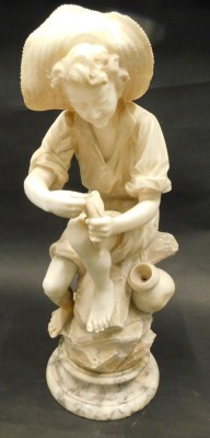 A 19thC marble and alabaster carving of a young fisherman, on a stylised rock base with moulded socle, probably Italian, 67cm high.