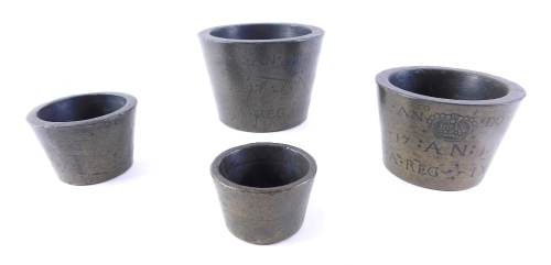 A graduated set of bronze bucket weights, engraved ANNO flanking a crown, 1710 AN REG 1X, 8cm high, 10cm diameter. (4)