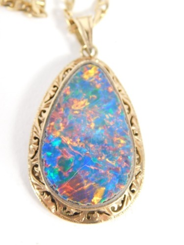 An opal doublet tear drop pendant, marked 14k, 4cm high, attached to a heavy link necklace, marked 375, 11.3g all in.