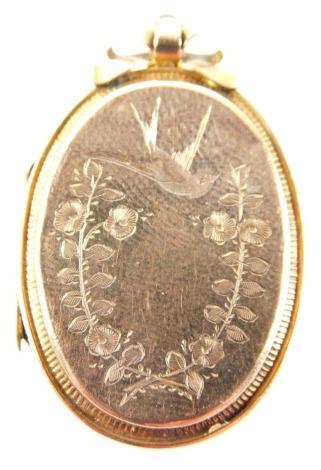 A Victorian sweetheart locket, with bow design top, with swallow and floral swag, marked 9ct gold back, 3cm x 2cm.