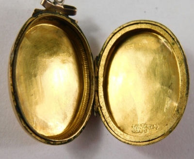 A Victorian sweetheart locket, with bow design top, with swallow and floral swag, marked 9ct gold back, 3cm x 2cm. - 3