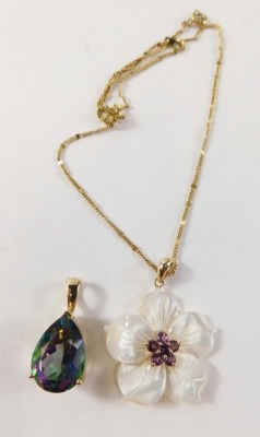 A 9ct gold pendant, with mother of pearl flower set with central amethyst, on a 9ct gold clasp, 3cm high, on a later plated chain, 3.6g and a mystic topaz pendant, in yellow metal clasp stamped 375, 5.8g. (2) - 2