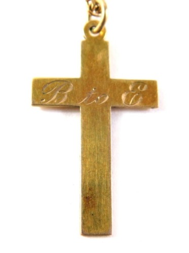 A crucifix pendant and chain, the crucifix inscribed B2E, yellow metal stamped 9ct, on a plated chain, the crucifix 1.4g.