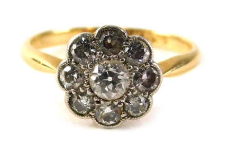 A diamond floral cluster ring, the daisy set with central old cut diamond approximately 0.12 carats, surrounded by eight tiny diamonds each approximately 0.04 carats, on a yellow metal band marked 18ct, ring size J, 2.2g all in.