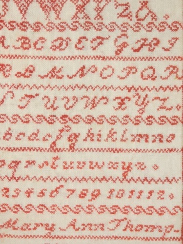 A Victorian alphabetic and numeric sampler by Mary Ann Thompson, 1863, 41cm x 22cm.