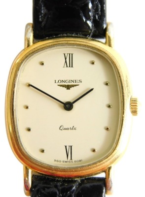 A Longines quartz wristwatch, with oval 2cm wide dial with baton and Roman numeric numerals, black leather strap, in outer case with paperwork.