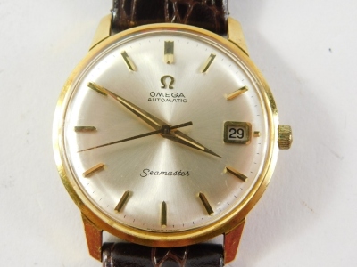 An Omega Seamaster automatic wristwatch, the silvered 3cm diameter dial with baton pointers and numerals, with date aperture and textured leather strap, with outer case and paperwork. - 3